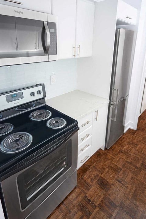 an empty kitchen with a stove and a refrigerator